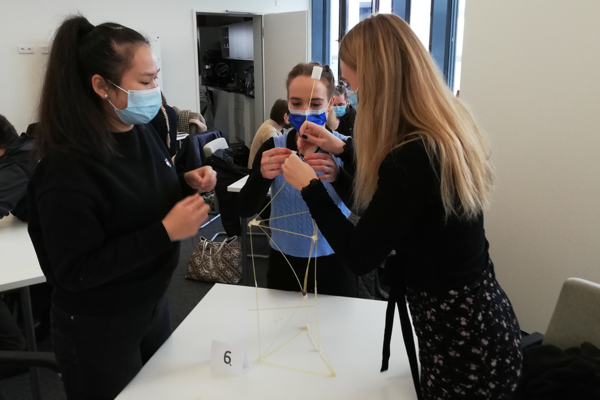 Drei Workshop-Teilnehmerinnen lösen gemeinsam eine Aufgabe.